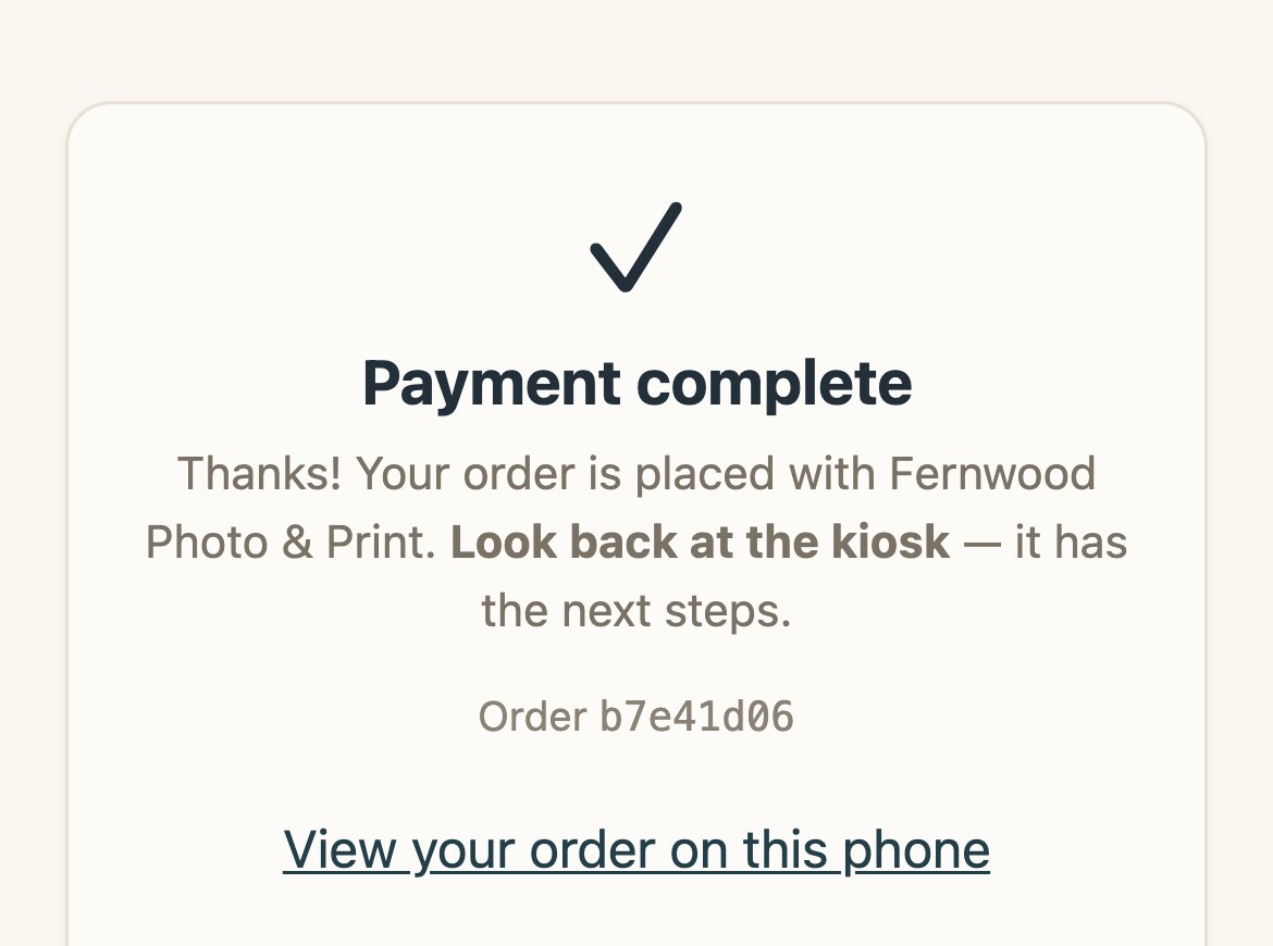 The customer's phone after paying: a check mark, Payment complete, and Look back at the kiosk
